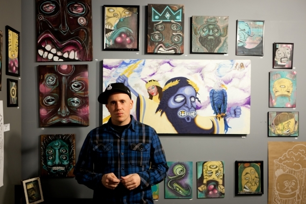 Artist Ryan Worwood poses with his work. Photo by Brent Rowland