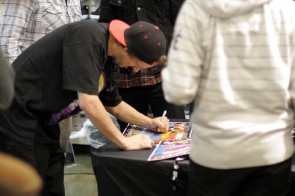 Dylan Thomson, Pro rider for Neff, signs autographs for some fans.