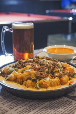 A liter of beer nicely complements Legends’ tomato bisque and Totchos—tater tot nachos! Photo: Talyn Sherer