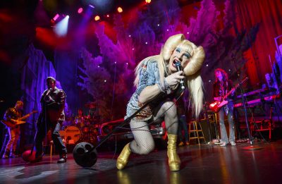 Hedwig (Euan Morton) enters the stage in pumps, glitter and a rage, sweeping the audience off their feet with her powerful vocals.