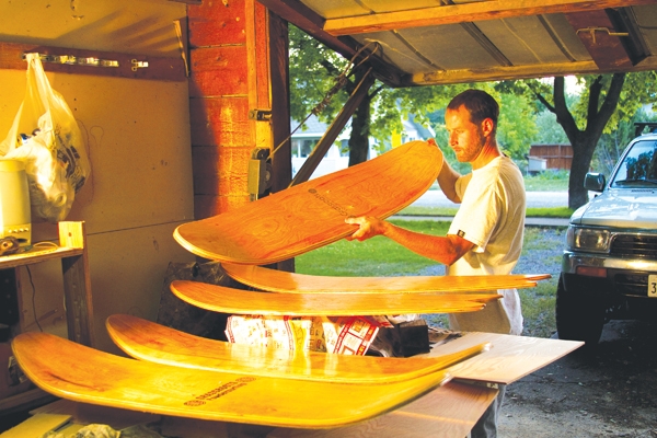 Jeremy Jensen in his garage crafting Grassroots boards.