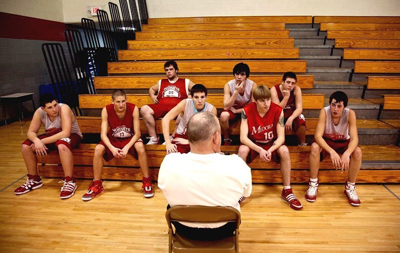 Still from Medora of Indiana basketball players and basketball coach.