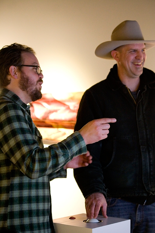 Trent Call talks about his exhibit with visitor Brad Wheeler at the UMOCA.