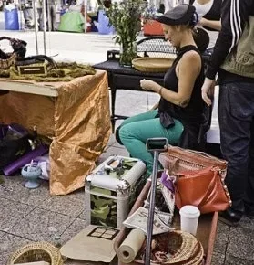 Woman sitting in a chair at an artist booth.