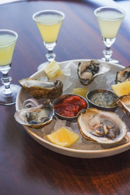 Raw oysters with Oyster Back cocktails showcase Current’s seafood expertise. 