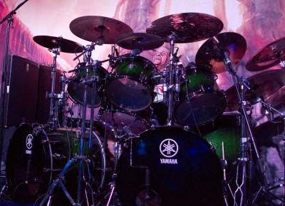 Exodus' Tom Hunting wails on his drums while wearing pigtails. Photo by Madi Smith.