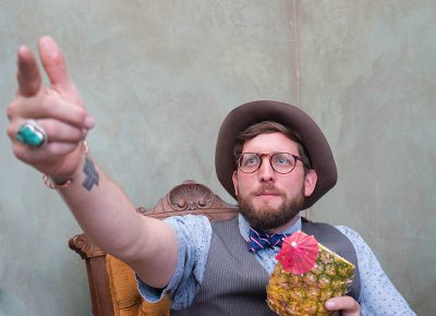 Portrait of Mister Pauper, Jake Buntjer from Provo, drinking a fancy pineapple beverage. Photo: JoSavagePhotography.com