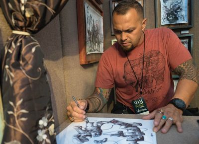 Murray-based artist Tai Taeoalli continues to create and draw with a ballpoint pen as people come in and admire his amazing art. Photo: JoSavagePhotography.com