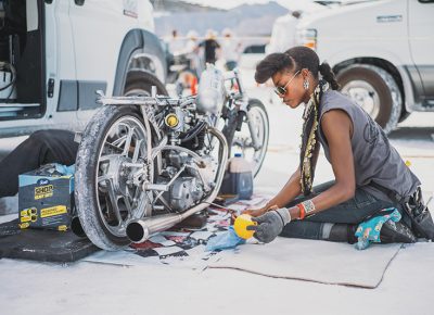 Jalika Gaskin of Alp Racing Design works on their record-breaking bike based on a 650cc 1950 Triumph engine. They beat the previous record of 133 mph in the 650 pushrod class with an average speed of 149 mph.