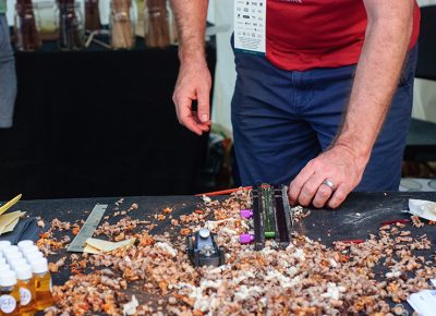 Ryan Carty carves custom chopsticks at the Hashi booth on Saturday. Photo: @snowlenda