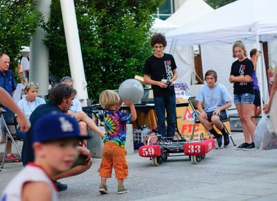 A child plays catch with a robot made by students involved with First Tech Challenge. Photo: @snowlenda