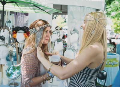 Mandy Williams (right) of Oculus Design helps an attendee try on one of her handmade headpieces. Photo: @clancycoop