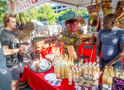 Cathy Tshilombo-Lokemba of Mama Africa explains her various hot sauces to a sold customer. Photo: @nellis_j