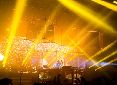 Doused in the golden shimmer of his light show, Flume envelops the crowd with both upbeat sound and angelic light. Photo: Colton Marsala