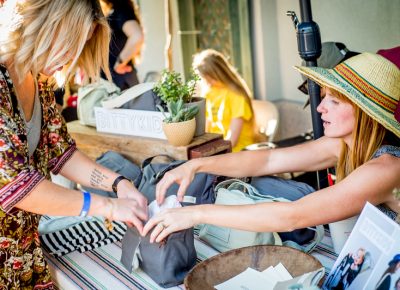 Holly Jo Hackett of Bitty Kids shows a customer the various features of her handmade bags, which are specially designed for parents who don't want to give up their lifestyle of adventure. Photo: @nellis_j
