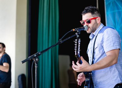Singer/Guitarist Michael Gross of The Statuettes playing on the SLUG Magazine Main Stage. Photo: @LMSorenson