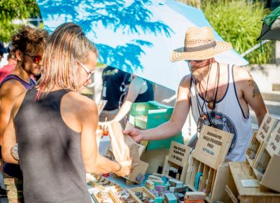 A satisfied customer walks away with a number of goods from The Hive Mind Apiary. Photo: @nellis_j