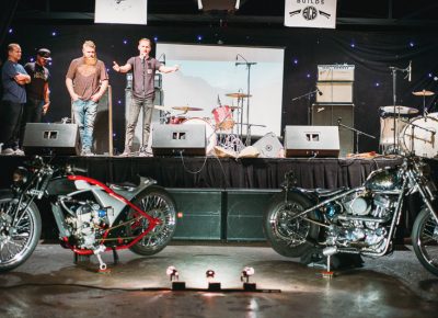 Jason "Rev" Clark announces the winners of the bike building contest: Don Cash for individual builds, and Adam Paul and Ryan Friedli for the invited builds class. Photo: @clancycoop