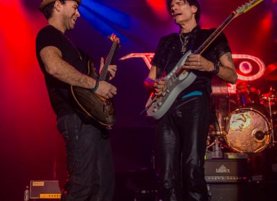 (L–R) Dave Weiner and Steve Vai battle it out onstage, to the amusement of the crowd. Photo: Talyn Sherer