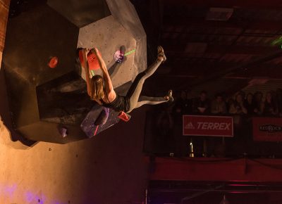 Claire Buhrfeind lands a massive move on the second women's problem as her feet swing above her head. Photo: ColtonMarsalaPhotography.com