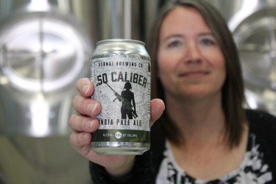 Vernal Brewing Co.'s Owner Ginger Bowden offers a sample of .50 Caliber, their India Pale Ale. Photo by Chris & Sylvia Hollands.