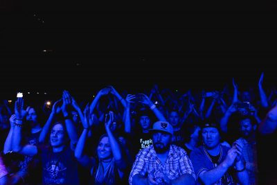 Fans of Flogging Molly being bathed in blue light during the set. Photo: Lmsorenson.net