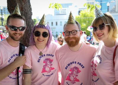 (L–R) Eric Taylor, Heather Mahler, Gage Love and Ashley Love can’t wait to march for pride. Ashley Love designed SLUG’s T-shirt this year. She took inspiration from the Gender Unicorn used to teach children the complexities of gender, sex and attraction. Photo: John Barkiple
