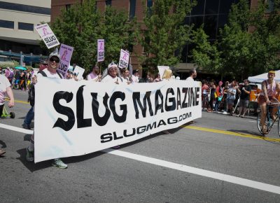 SLUG Magazine has proudly marched in the last dozen Pride parades, and SLUG has won many awards from the Pride Parade officials. Count on SLUG to offer up clever parade attire and sassy innuendo. Photo: John Barkiple