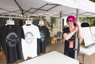 Ruby Barnes from Graywhale Entertainment setting up the merch tent at Ogden Twilight. Photo: Lmsorenson.net