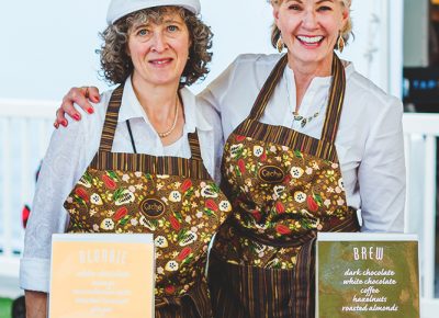 (L–R) Bobbie Wolbach gets a photo with her longtime friend and Cache Toffee Collection owner Lori Darr. Photo: Talyn Sherer