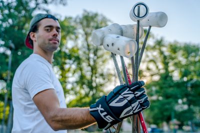David Barthod holds the mallets. Before each game, the players’ mallets are tossed in the air to see who is on what team. Photo: Jo Savage // @SavageDangerWolf