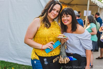 (L–R) Vine Lore reps Tatiana Subbotin and Whitney Norton passed out golden cork necklaces for those wishing to win a custom made firepit. Photo: Talyn Sherer