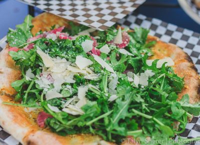 Fire & Slice Wood Fire Pizza sampled out their house specialty pie made with fresh arugula, white balsamic and honey vinaigrette, pickled red onion, and a three-cheese blend. Photo: Talyn Sherer