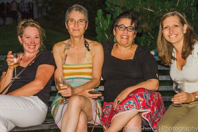 (L–R) Ginger Steensma, Sally Padawer, Amy Martin and Aurelie Ferrut wind down the night with a glass of white wine on a park bench. Photo: Talyn Sherer