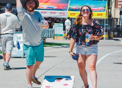 Couldn't imagine a better way to enjoy the nice summer weather than an ice-cold glass of draft beer and a game of cornhole. Photo: Talyn Sherer