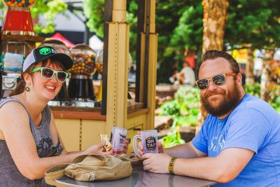 (L–R) Emily Park and Bryant Gordon chill in the shade and converse over their favorite beers. Photo: Talyn Sherer