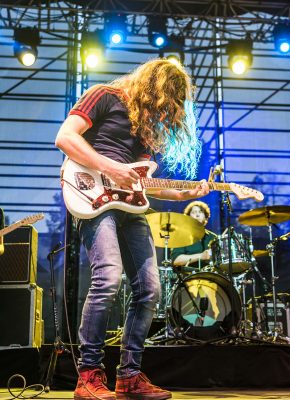 Kurt Vile, illuminated in yellow and blue stage light. Photo: ColtonMarsalaPhotography.com