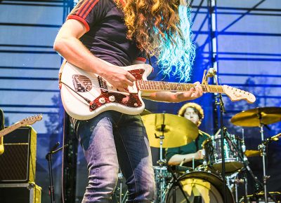 Kurt Vile, illuminated in yellow and blue stage light. Photo: ColtonMarsalaPhotography.com