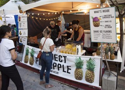 A woman orders at the front of a line for drinks from Perfect Pineapple. Photo: @jbunds