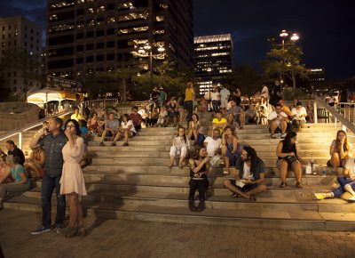 Patrons sit on the steps of the Gallivan Center watching a band at the south end of the festival. Photo: @jbunds