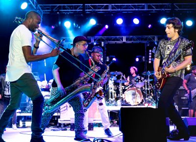 Trombone Shorty and other band members circle guitarist Pete Murano as he plays a solo. Photo: Lmsorenson.net