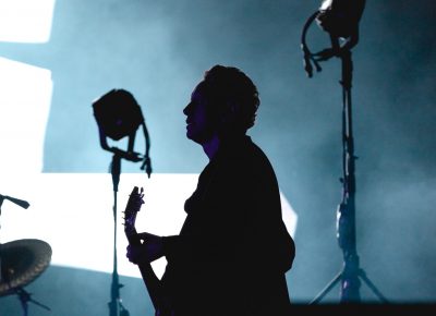 The silhouette of Martin Gore with shining lights from the giant display behind. Photo: Lmsorenson.net
