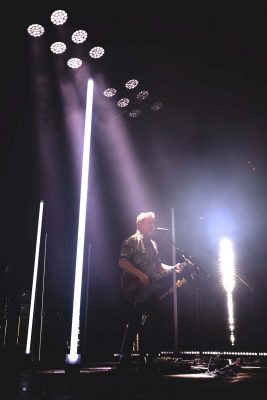 Lead singer Josh Homme stands stage right with a beam of spotlight over him as he provides vocals. Photo: Lmsorenson.net