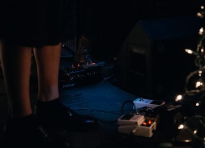 The dimly lit stage was illuminated faintly by the glow of Christmas lights and effects pedals. Photo: Matthew Hunter
