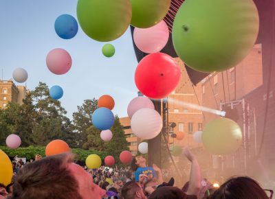 Large colorful balls float above the crowd. Photo: ColtonMarsalaPhotography.com