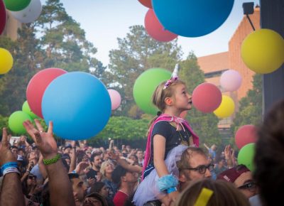 A young fan watches the show as colorful balls dance in the sky. Photo: ColtonMarsalaPhotography.com