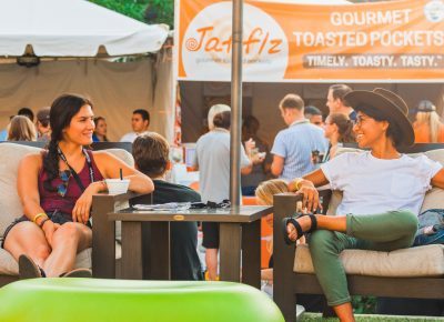 (L–R) Alli Blake and Karina Soriano of Dented Brick Distillery lounge on the chairs and enjoy some friendly conversation. Photo: Talyn Sherer
