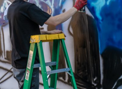 Local artist Just242 painting a mural of SLC. Photo: Randy Roberts