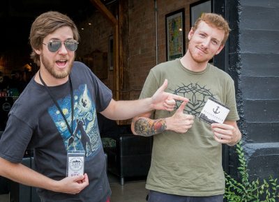 (L–R) Ben Gabrielsen and Alec Stanczyk step outside to take a break from SLAMM’s heady buzz. Stanczyk bought Black Harbor strings, which he’ll use when he plays in his band, Hemwick, up in Ogden.