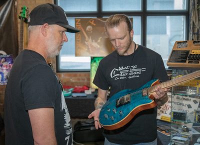 KSM Music’s Repair Technician, David Kirkham (right) builds guitars on the side for his Malyse Intende company. He refinishes, burns and airbrushes 100-percent custom guitars to order